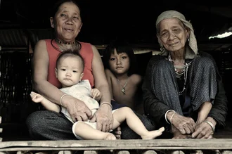 Photo art by Haifeng Ni: Three generations of a family in a bamboo hut