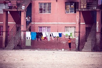 Laundry hangs on a staircase in Worcester, illuminated by soft windows.