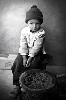 Portrait of a boy in Kathmandu smiling gently at the camera.