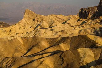 Photo art by Ana Fieres: Zabriskie Point at sunrise with gentle sand dunes.