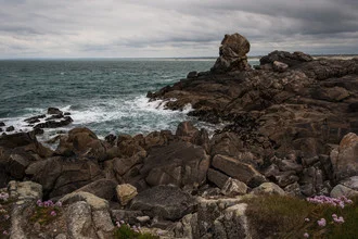 Waves crashing against rocks at Pointe de la Torche on the Brittany coast.