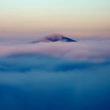 Photo art by Martin Rak: mist envelops a mountain peak in the Bohemian Switzerland