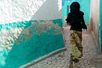 Photo art of a running girl in Ethiopia, vibrant colors with a village backdrop.