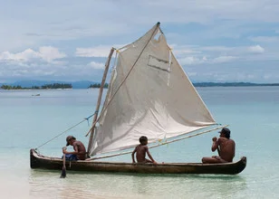 Men at work in Panama: scene with fishing boat and calm water