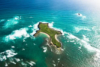 Photo art by Lars Jacobsen: Aerial view of Goat Island with waves and sunlight