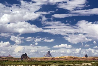 Expansive landscape of Monument Valley, Arizona, featuring distinctive rock formations under a clear sky.
