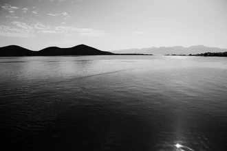 Photo art by Victor Bezrukov: black-and-white capture of Crete's coast with mountains in the background.