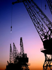 Hanging moon over a harbor, warm light and urban vibe create a calm atmosphere.