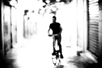 Photo art by Nasos Zovoilis: Man on a street in Athens at night