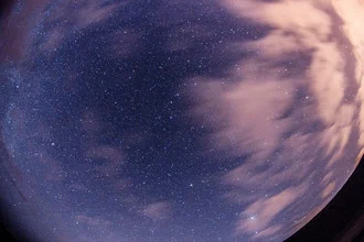 Photo art: night sky with the Ursa Major constellation over a tranquil landscape