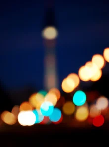 Colorful Berlin at night with a glowing TV tower and vibrant lights.