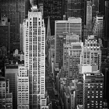 Black-and-white photo of New York: skyscrapers in an urban street canyon