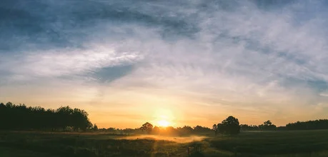 Photo art: gentle sunrise over a foggy field with clouds