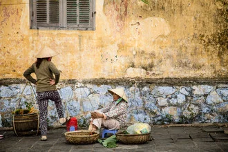 Woman speaking on the street in Hanoi, Vietnam, in a lively urban setting.