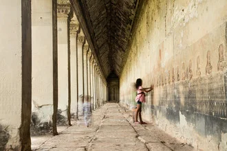 Columned corridor in Cambodia: cheerful children playing in the shade
