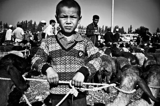 Photo art by Brett Elmer: boy in black and white in Kashgar, China.