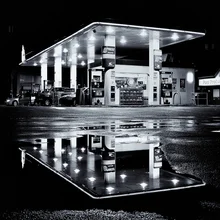 Photo art by Jianwei Yang: Rain is over, reflection in a puddle at a gas station