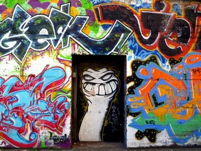 Photo art by Anuschka Wenzlawski: friendly doorman in front of a colorful wall.