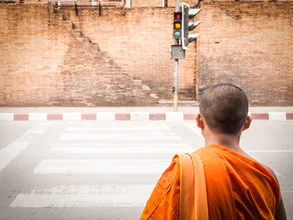 Photo art by Johann Oswald: monk crossing a street in Chiang Mai, Thailand.