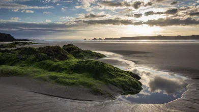 Photo art by Monika Schwager: calm bay with water reflections and clouds.