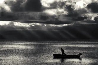 Black and white photo art: man in a boat on the calm Adriatic waters at the horizon