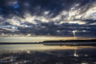 Clouds over the sea, gentle evening mood with rays of light at the beach