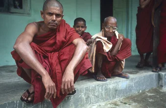Photo art by Martin Seeliger: monk in traditional robe, sitting calmly in a monastery.