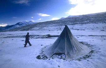 Photo art by Martin Seeliger: snow-covered mountains and tent in the Himalayas
