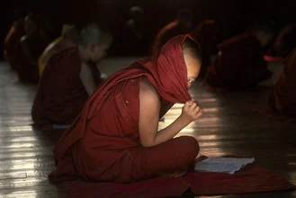 Photo art by Martin Seeliger: shy young monk in traditional robe