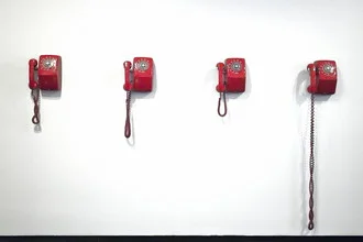 Photo art by Jeff Seltzer: telephones in a hotel with a red background