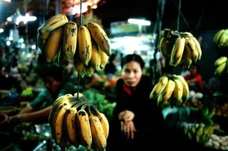 Colorful market scene in Cambodia with fresh bananas and lively stalls