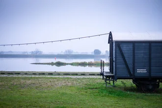 Photo art by Andi Weiland: a blue wagon by the riverside in Groß Neuendorf