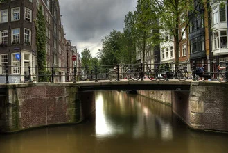 Photo art by Björn Groß: bikes by the canal in Amsterdam under sunlight