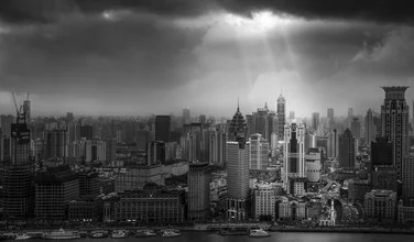 Photo art by Rob Smith: shafts of light breaking through dark clouds over Shanghai