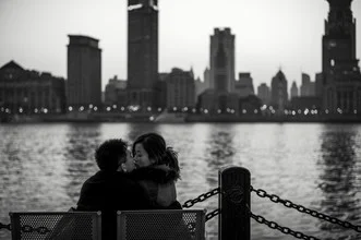 Charming photo of a kissing couple in Shanghai's Bund at night.