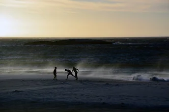 Photo art by Gabriele Spörl: Children playing on the beach in Camps Bay during sunset.
