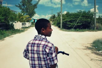Wall art: Boy riding a bike in a relaxed street setting