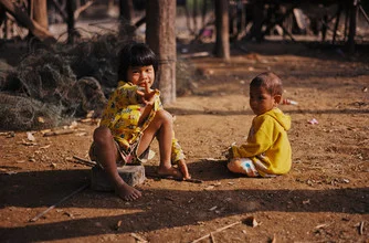Photo art by Jim Delcid: children in a floating village in Cambodia