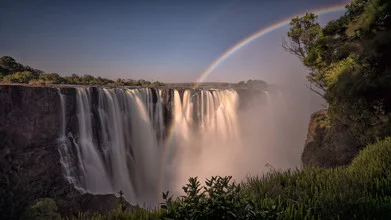 Rainbow over Victoria Falls in Zimbabwe, gentle water flow and colorful atmosphere