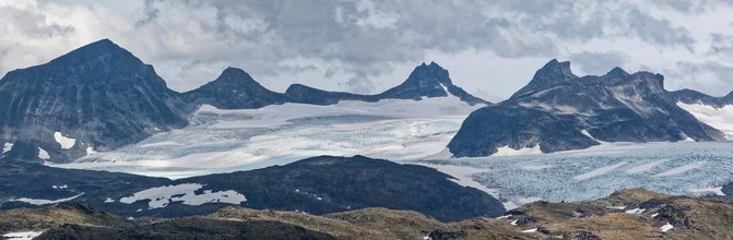 Photo art by Silvia Becker: snow-covered mountains under a cloudy sky in Norway