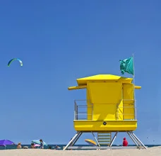 Wall art featuring a lifeguard tower on a sunny Spanish coast