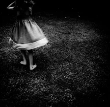 Photo art by Alicja Brodowicz: a girl in a skirt smiling in nature