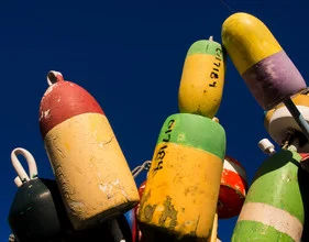 Photo art by Aurica Voss: colorful buoys on the Cape Cod coast on a summer day
