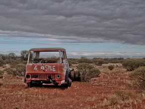 Photo art by Tobias Vahlpahl: scrap in the Australian outback under a cloudy sky