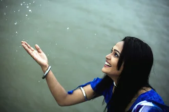 Photo art by Mohammad Arifur Rahman: girl smiling under raindrops.