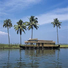 Photo art by Bernhard Lang: serene landscape with houseboat and palm trees in Kerala