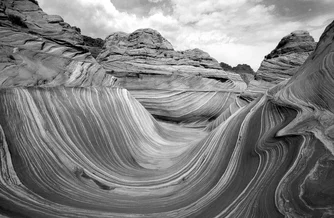 Photo art by Peter Fauland: soft sandstone waves in black and white.