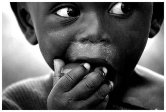 Photo art by David Samaranch Rebull: a child sharing tomatoes in Uganda