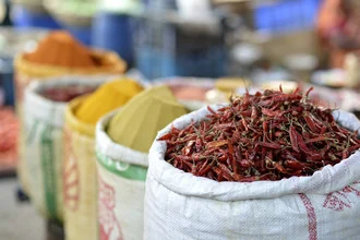 Vibrant photo of a spice market in Bangladesh featuring chilies and spices