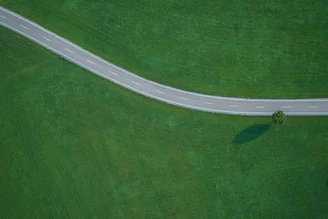 Highland by Jochen Fischer: aerial view of green fields and roads